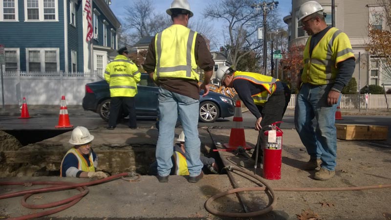 Workers repair gas pipes under the street.